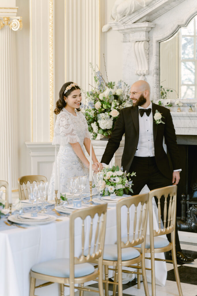 The bride and groom seeing the fine art wedding reception table for the first time.